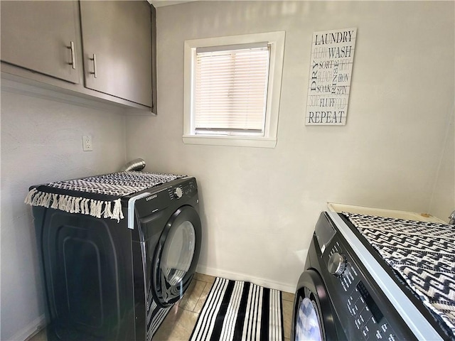 laundry area featuring baseboards, cabinet space, and tile patterned flooring