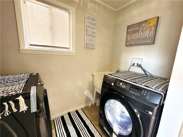 clothes washing area with crown molding, tile patterned flooring, baseboards, washer / dryer, and laundry area