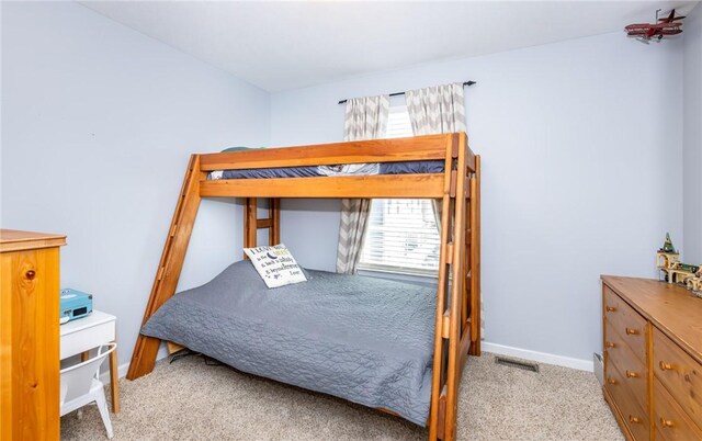 bedroom featuring visible vents, baseboards, and carpet floors