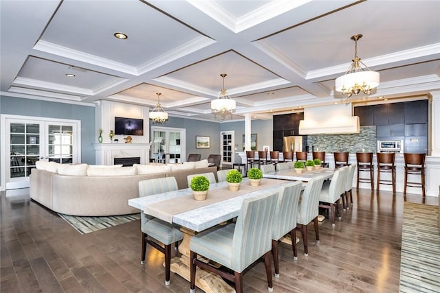 dining area with dark wood-style floors, coffered ceiling, a fireplace, beamed ceiling, and a notable chandelier