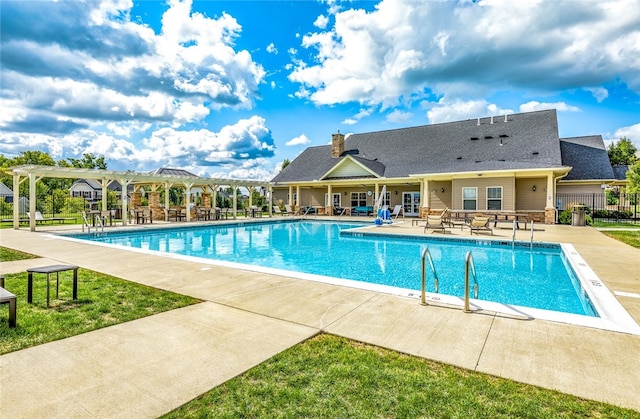 community pool featuring a patio area, a pergola, and fence