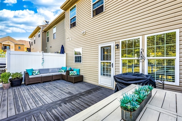 wooden terrace featuring a grill, outdoor lounge area, and fence