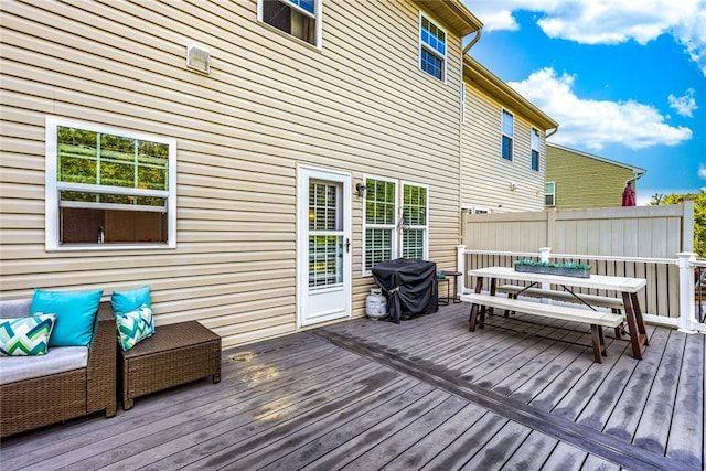 deck featuring outdoor dining space and area for grilling