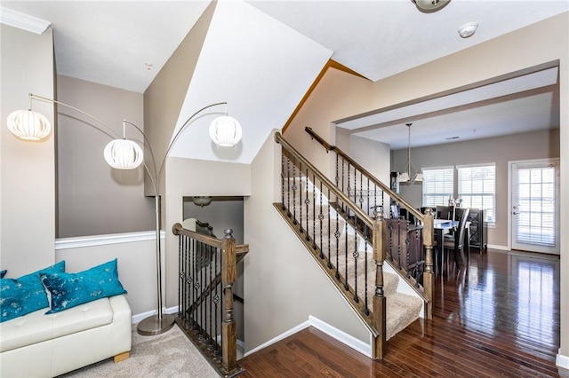 stairs featuring wood finished floors and baseboards