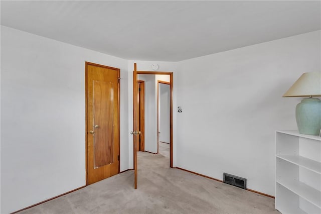 unfurnished bedroom with visible vents and carpet floors