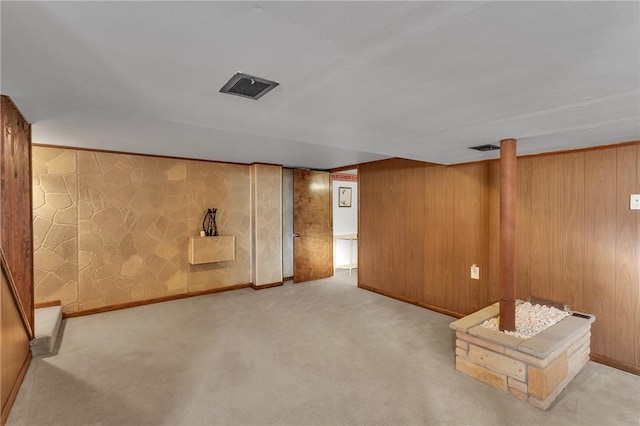 finished basement featuring visible vents, baseboards, and carpet flooring