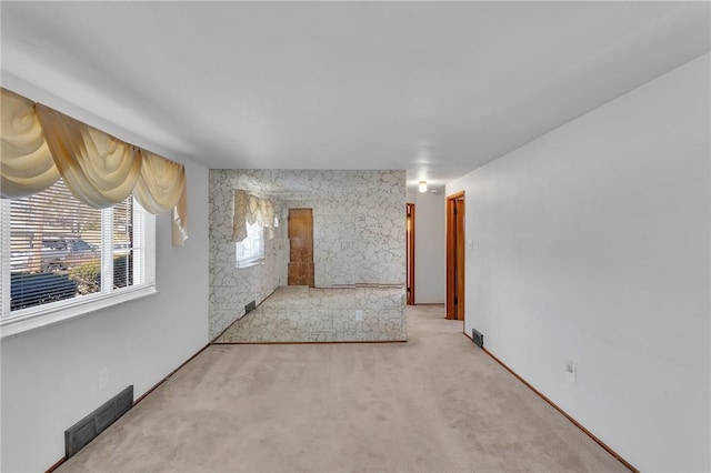 empty room with visible vents and carpet