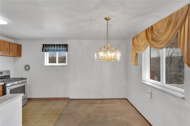 dining space with a notable chandelier and baseboards