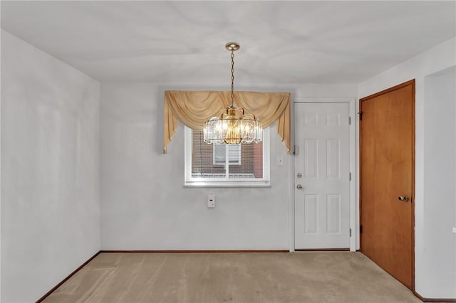 empty room with light carpet, a notable chandelier, and baseboards