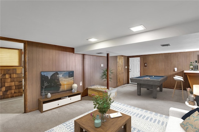 carpeted living room with pool table, visible vents, and wood walls