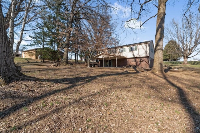 rear view of house with brick siding and a wooden deck