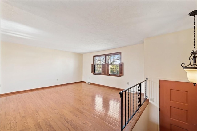 interior space with baseboards and wood-type flooring