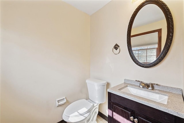 half bath featuring toilet and vanity