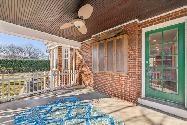 view of patio with ceiling fan and fence