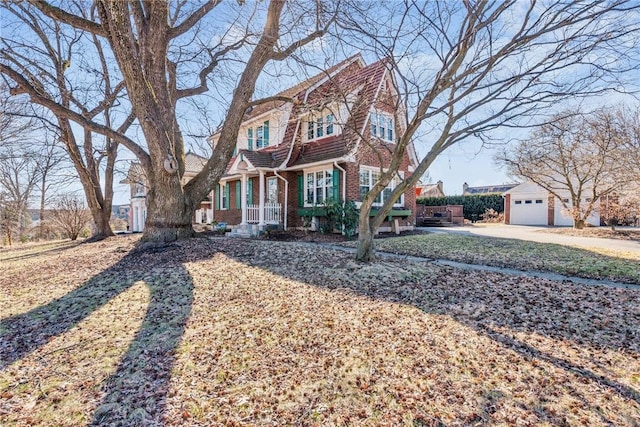 view of front of property featuring an outbuilding and brick siding