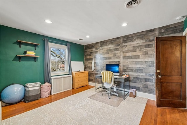 office area with visible vents, radiator, an accent wall, recessed lighting, and wood finished floors