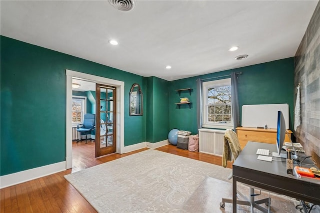 office with visible vents, baseboards, hardwood / wood-style floors, and french doors