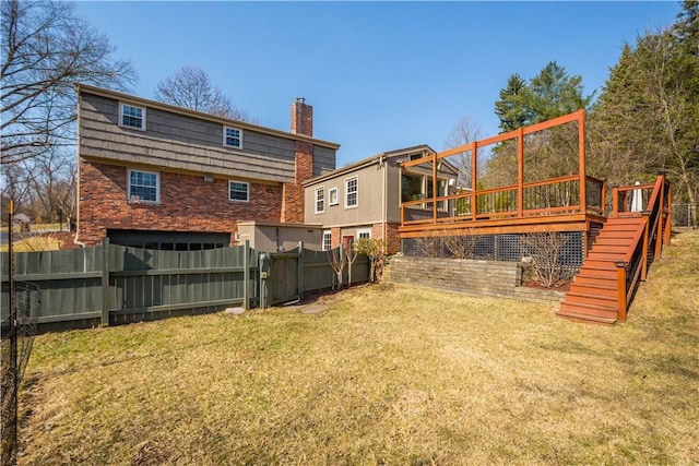 view of yard with a wooden deck, stairs, and fence