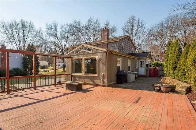 deck with grilling area and an outdoor fire pit