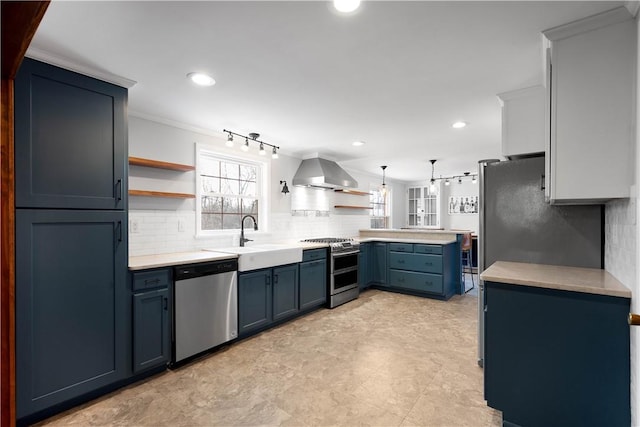 kitchen featuring range hood, open shelves, a sink, stainless steel appliances, and blue cabinets