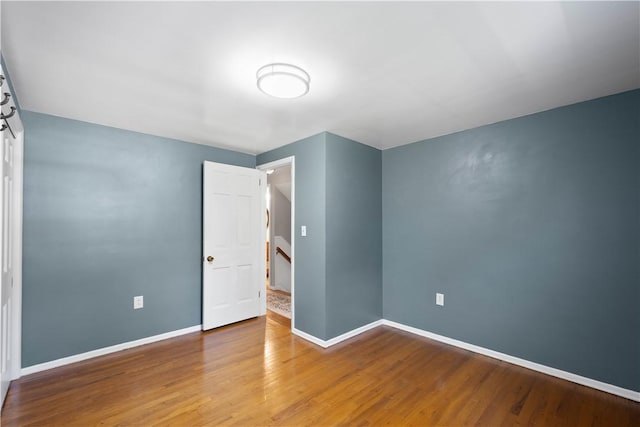 unfurnished bedroom featuring baseboards and wood finished floors