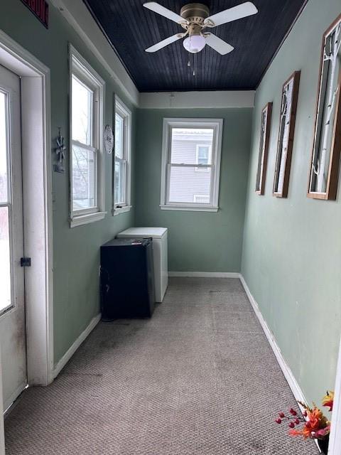 spare room featuring light carpet, a healthy amount of sunlight, and ceiling fan