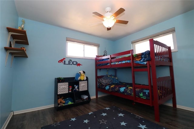 bedroom featuring a ceiling fan, wood finished floors, and baseboards