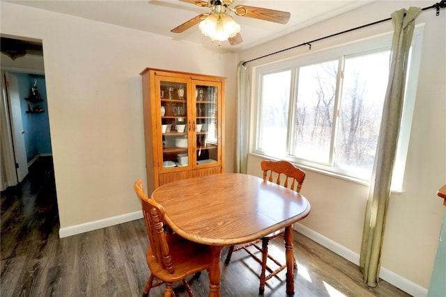 dining area with baseboards, a ceiling fan, and wood finished floors