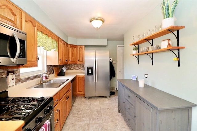 kitchen with open shelves, a sink, stainless steel appliances, brown cabinets, and backsplash