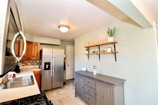 kitchen featuring brown cabinetry, open shelves, stainless steel fridge with ice dispenser, a sink, and tasteful backsplash