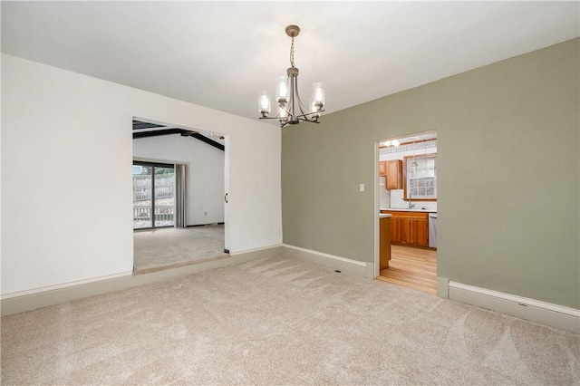 unfurnished room featuring light carpet, a chandelier, and baseboards