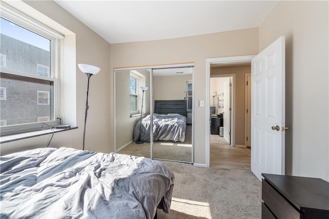 bedroom featuring carpet, a closet, and baseboards