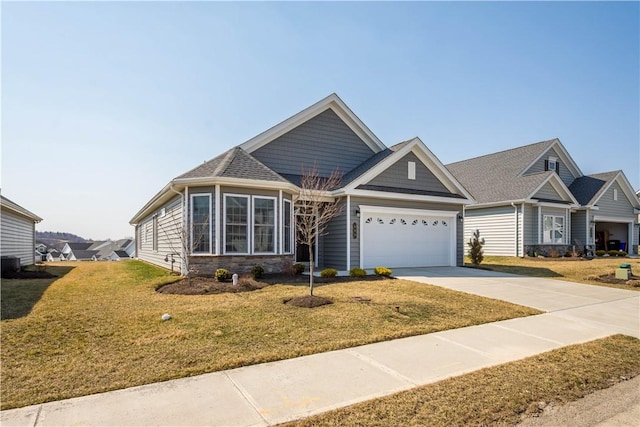 view of front of property featuring an attached garage, concrete driveway, and a front yard