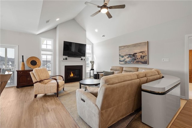 living area with a ceiling fan, light wood-style floors, and visible vents