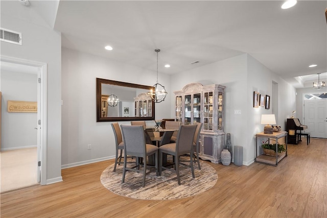 dining room with a notable chandelier, recessed lighting, visible vents, and wood finished floors