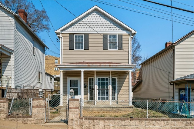 view of front of property with a gate, covered porch, and a fenced front yard