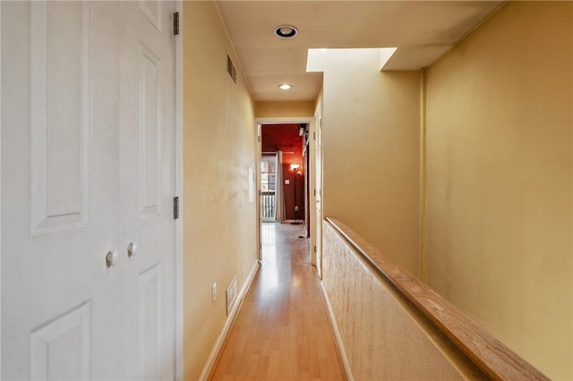 hallway featuring recessed lighting, baseboards, visible vents, and light wood finished floors