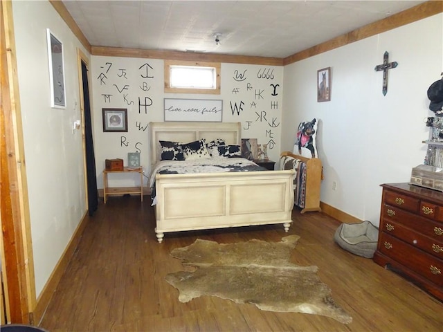 bedroom featuring dark wood-style floors and baseboards