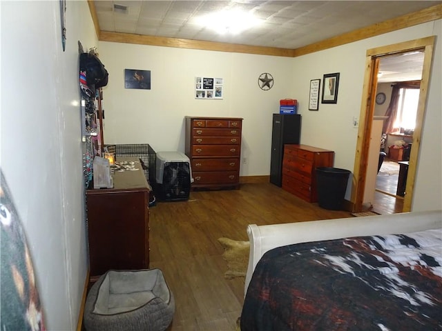 bedroom featuring visible vents and wood finished floors
