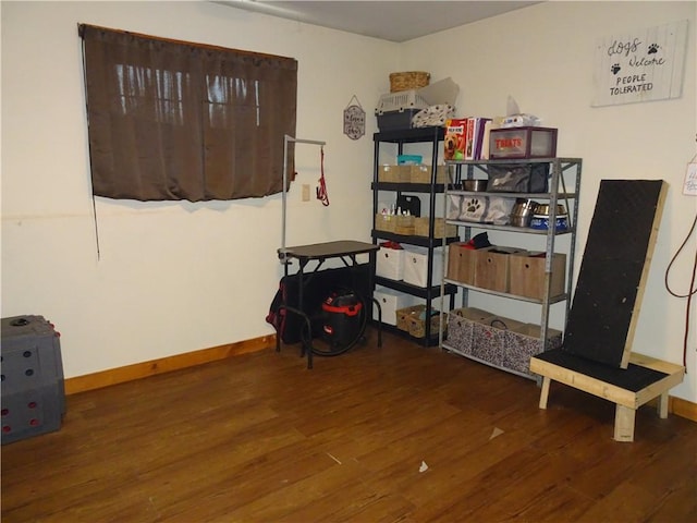 interior space with wood finished floors and baseboards
