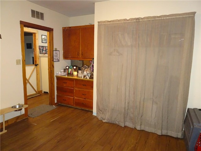 interior space featuring visible vents and wood finished floors