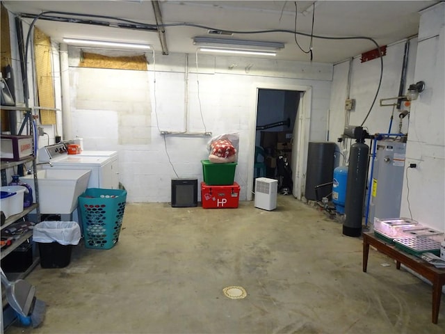 basement featuring washing machine and dryer and a sink