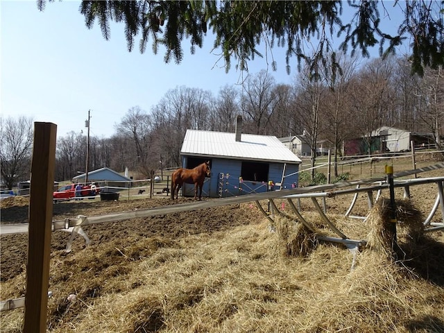 view of yard featuring an outbuilding and an exterior structure