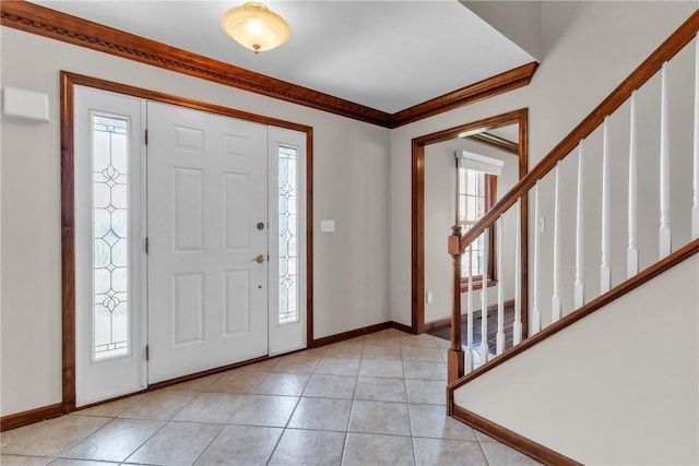 entryway featuring light tile patterned floors, stairway, baseboards, and ornamental molding