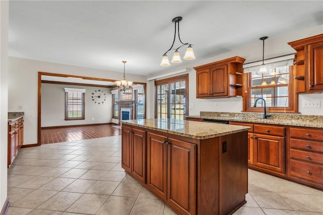 kitchen featuring open shelves, an inviting chandelier, light tile patterned flooring, a sink, and a center island