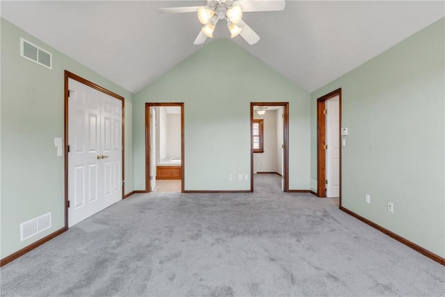 unfurnished bedroom featuring visible vents, baseboards, carpet floors, and vaulted ceiling