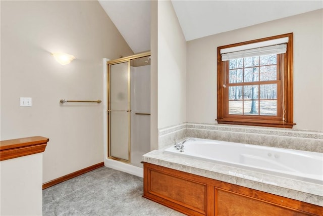 full bathroom featuring a bath, a stall shower, baseboards, and lofted ceiling