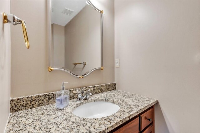 bathroom featuring visible vents and vanity