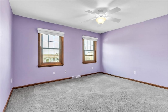 unfurnished room featuring visible vents, ceiling fan, baseboards, and carpet floors