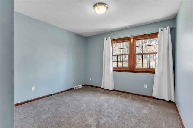 unfurnished room featuring visible vents, baseboards, and carpet